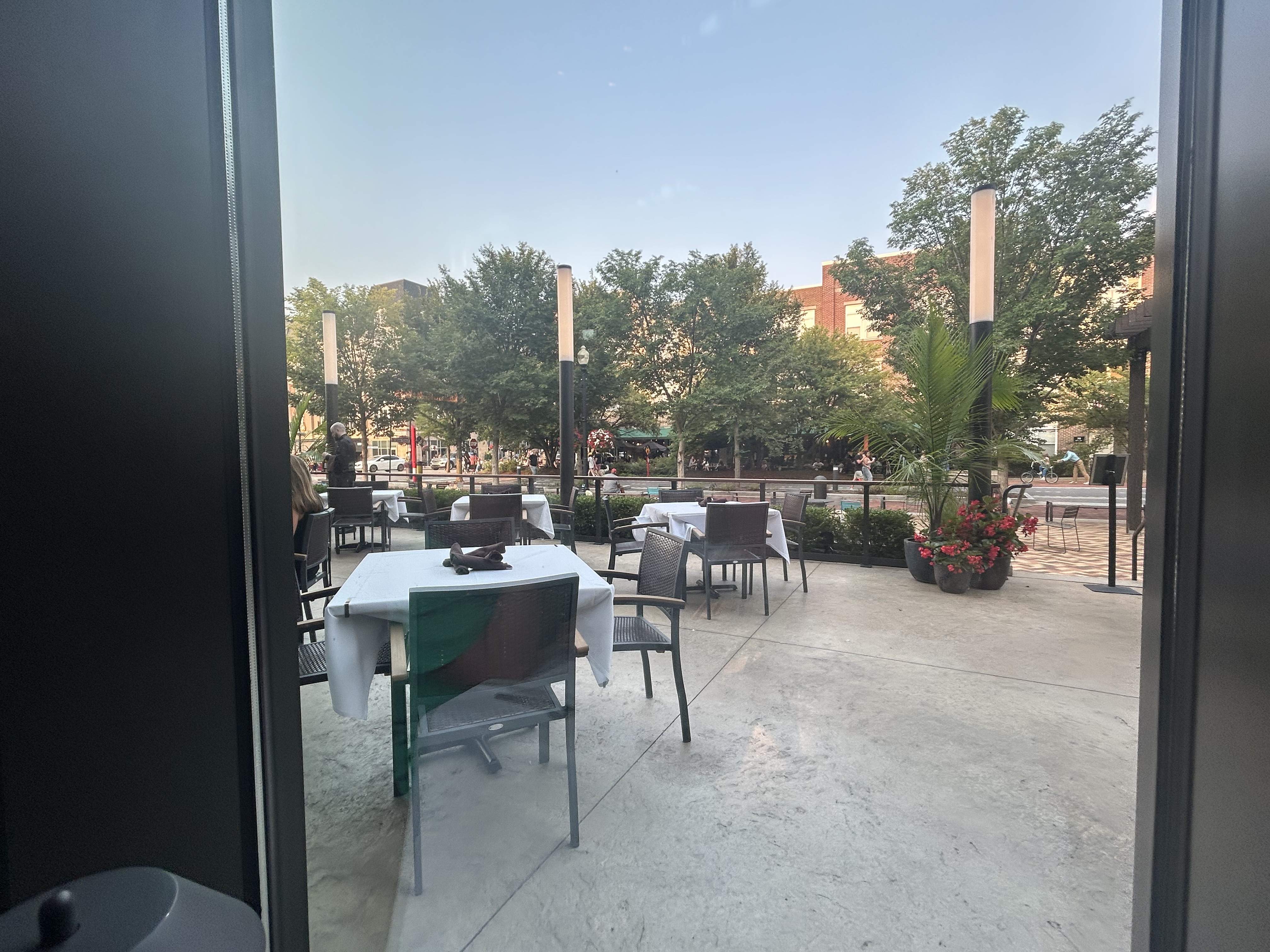 The view from inside Anthony's Chophouse out to the patio and Main Street at golden hour
