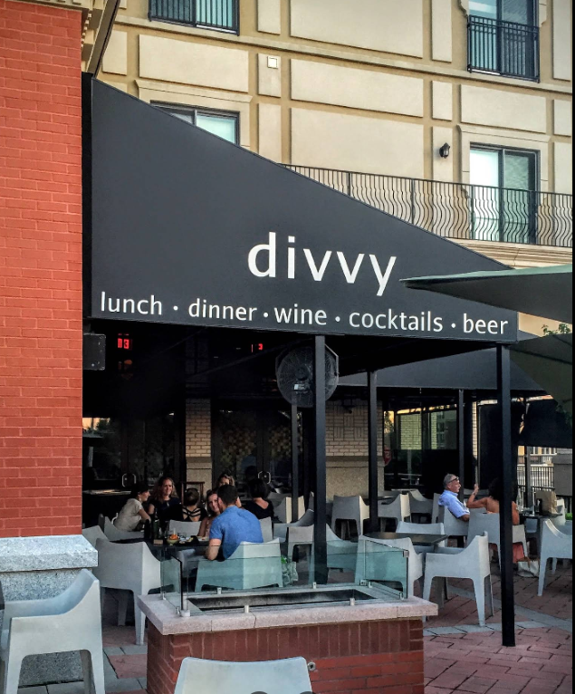 Fire pit seating on the Divvy patio with a view toward the Palladium