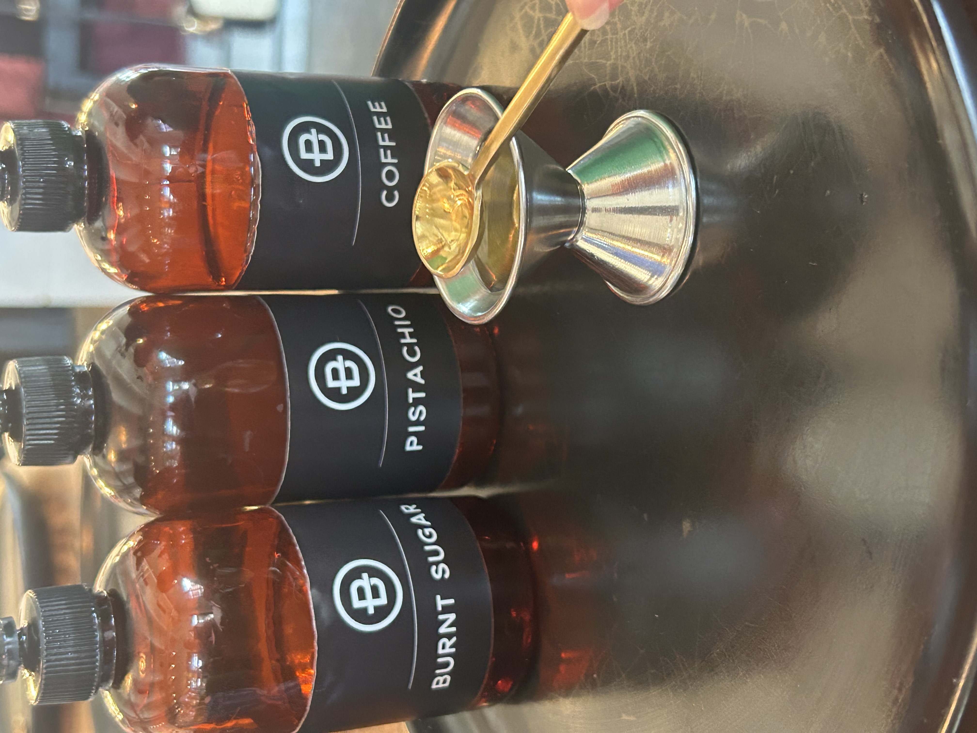 Burnt Sugar, Pistachio, and Coffee fragrance oils on a tray at Penn & Beech