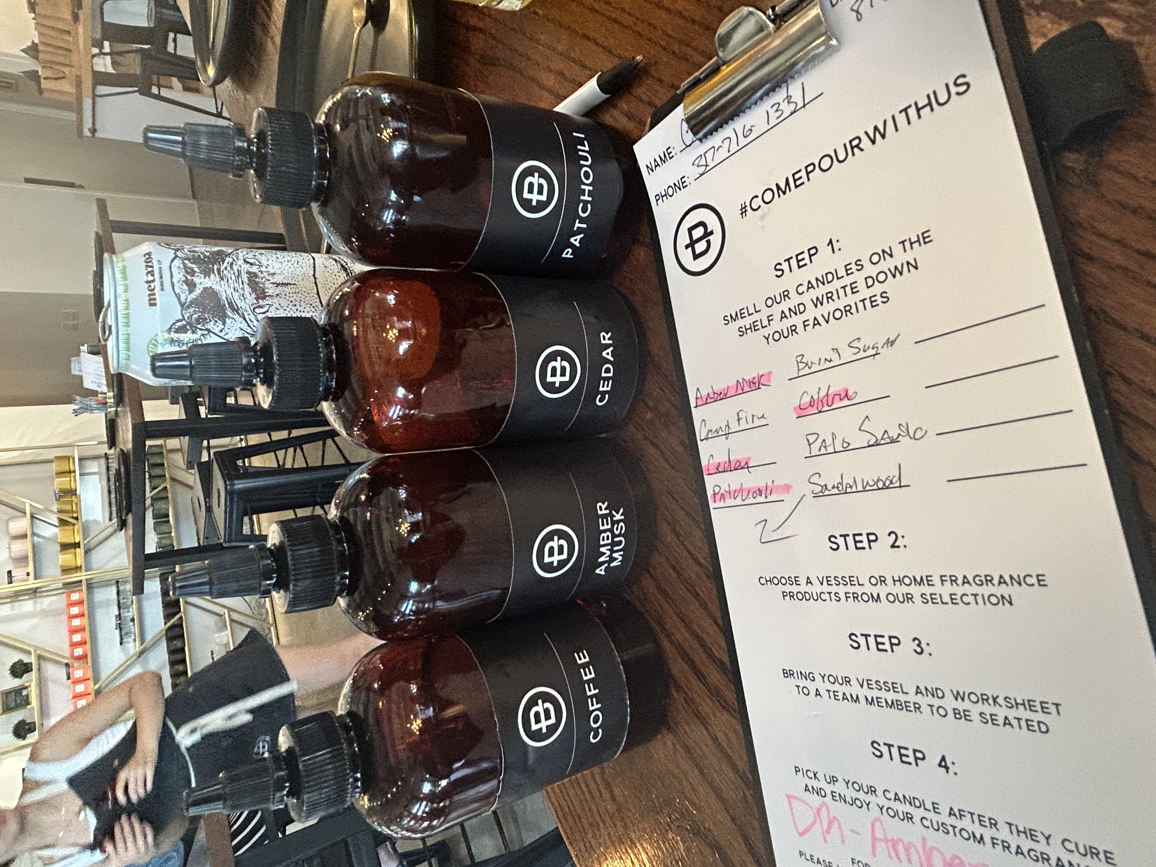 Fragrance oil bottles labeled Coffee, Amber Musk, Cedar, and Patchouli next to a Penn & Beech worksheet