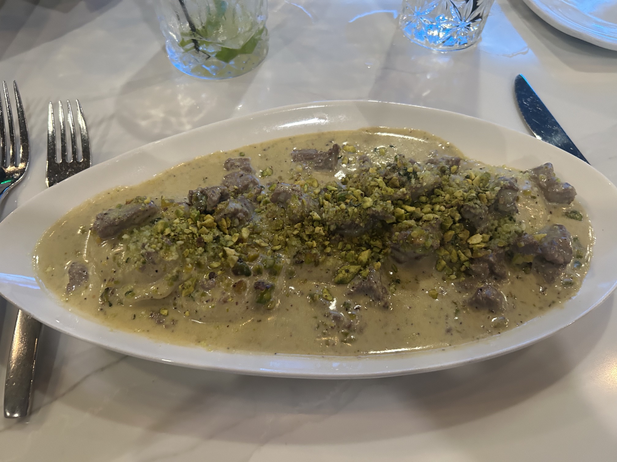 Ravioli Al Pistacchio E Filet, beef-stuffed ravioli in pistachio cream sauce with diced filet mignon, at Ristorante Roma