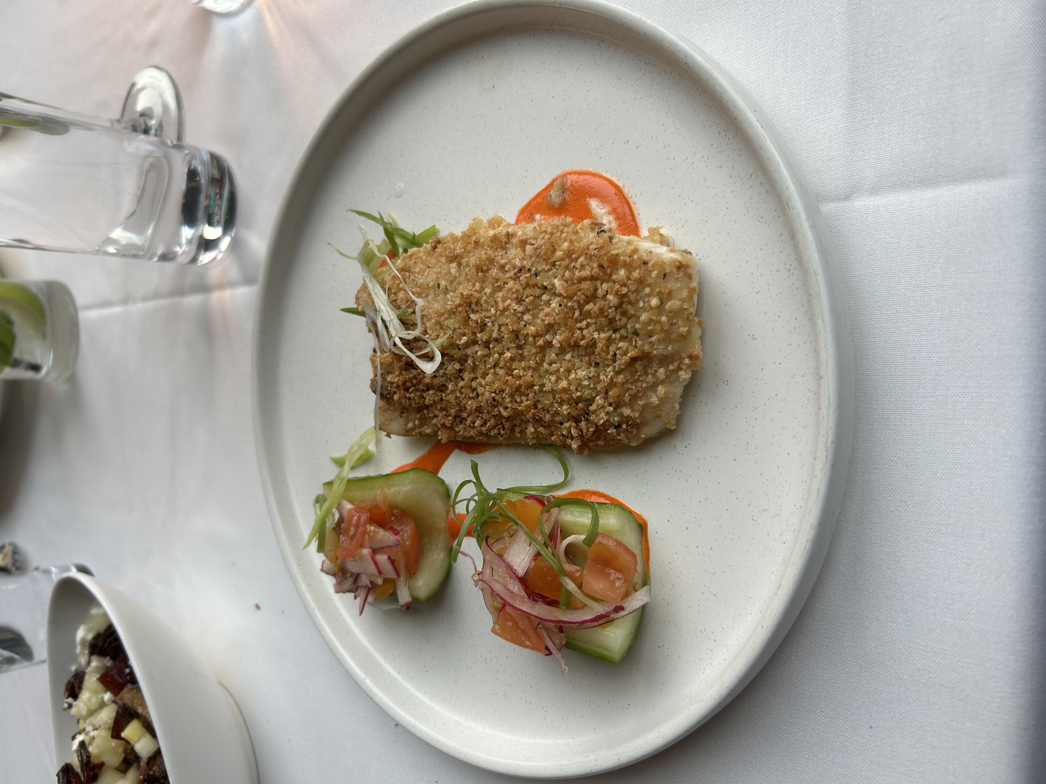Crusted red snapper with red pepper sauce and cucumber tomato salad